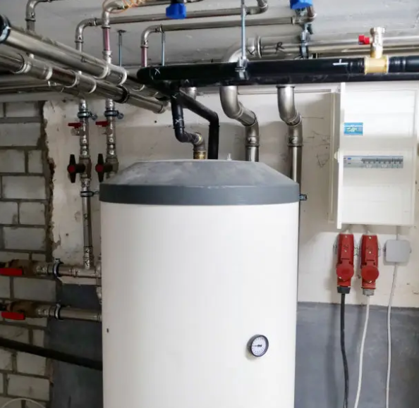 Storage water heater with overhead piping and shutoff valves in a utility room